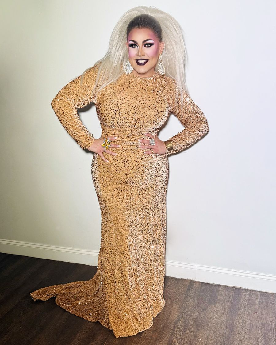 Abby Cummings in a floor-length gold sequin gown with platinum hair